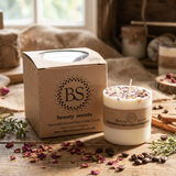 Medium handmade Rose Petals candle on a wooden table with scenic countryside view