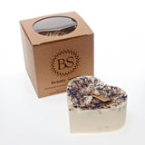 Large heart-shaped wild flower candle with kraft label, decorated with dried blue petals, shown with Beauty Scents gift box on white background