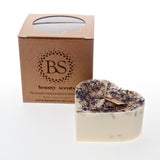 Large heart-shaped wild flower candle with kraft label, decorated with dried blue petals, shown with Beauty Scents gift box on white background