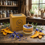 Small handmade wild flower candle with kraft label and dried blue petals, Beauty Scents gift box, dried mango and botanicals on rustic wooden table in country kitchen