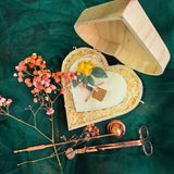 Top view of heart candle with lemon details in a wooden gift box