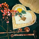 Large heart-shaped candle with lemon decorations in a wooden heart gift box