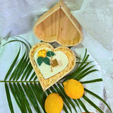Detailed view of wooden heart box and lemon candle, perfect gift
