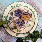 Decorative plate with a floral design and a small heart shaped candle with blue flowers